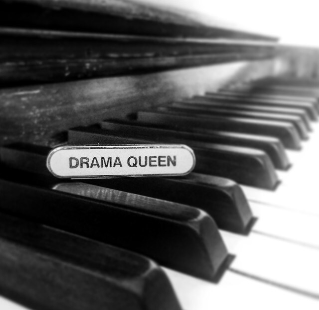 Drama Queen badge on a piano